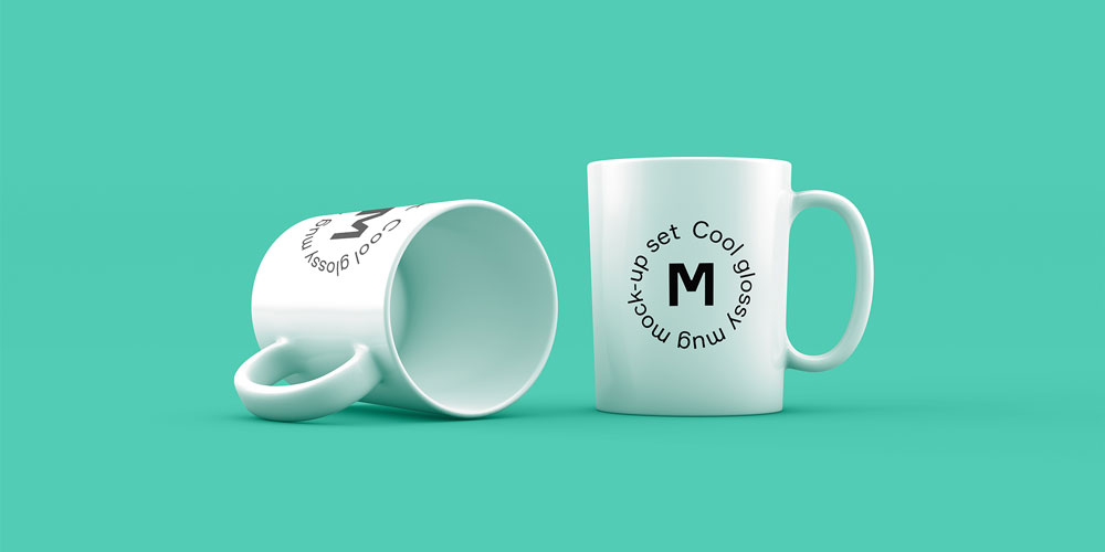 Two white glossy ceramic mugs, one standing upright and one lying on its side, against a vibrant teal background, perfect for branding mockups.